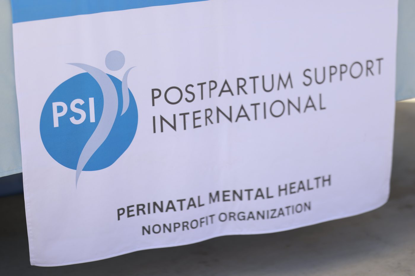 The Postpartum Support International banner at their table: Perinatal Mental Health Nonprofit Organization.