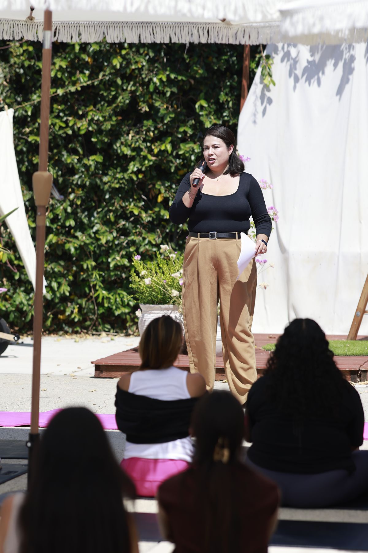 Guest speaker Gloria Torres, ACSW, addressing mothers seated on mats during the afternoon program.